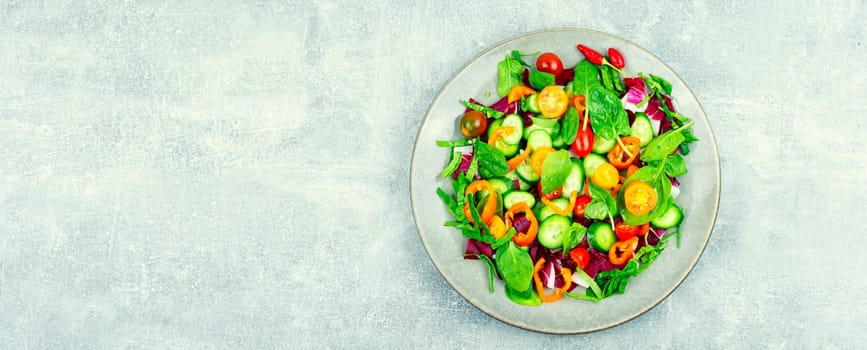 Spring salad of tomatoes, cucumbers, peppers and lettuce.