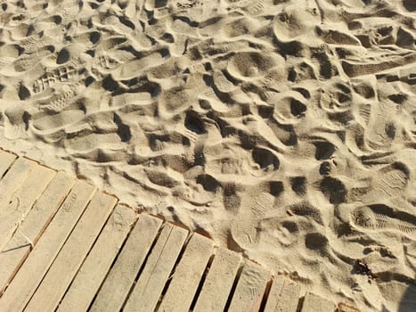 Wooden jetty on a sand beach