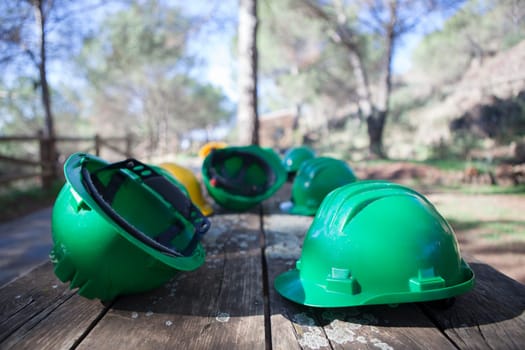 Mine The Jayona, declared natural monument. Fuente del Arco, Badajoz, Spain. Helmets over wooden table