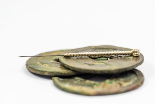 Acupuncture needle on chinese antique coin