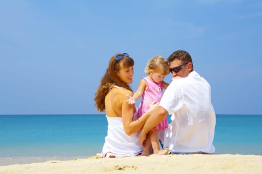 Portrait of young family having fun on the beach