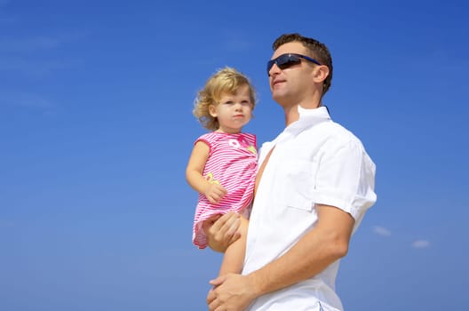 view of young family hanging out in summer environment.