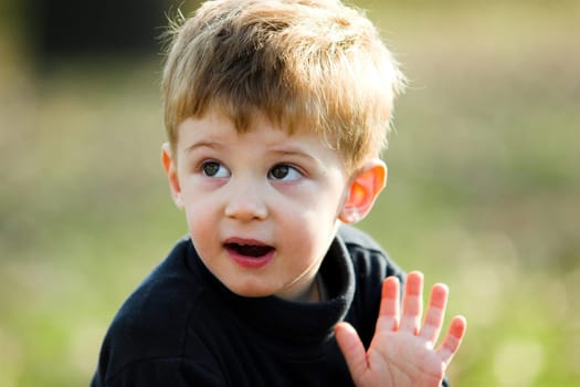 A little boy waving hand