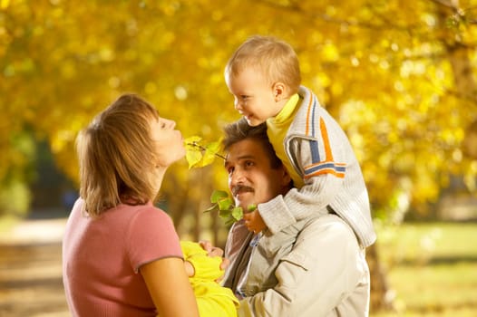 Family with children on walk in autumn park