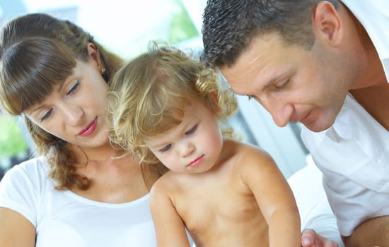 High key portrait of nice young family getting busy