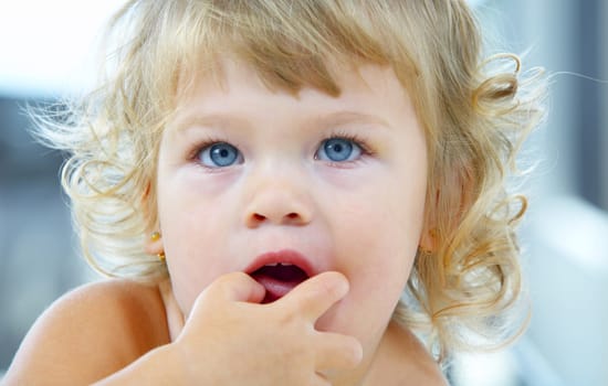 High key portrait of young blue eyed baby