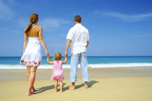 Portrait of young family having fun on the beach