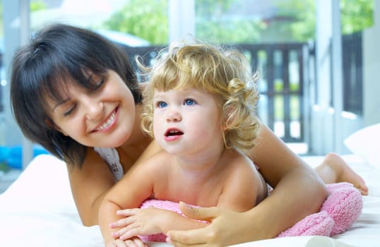High key portrait of happy mother with baby