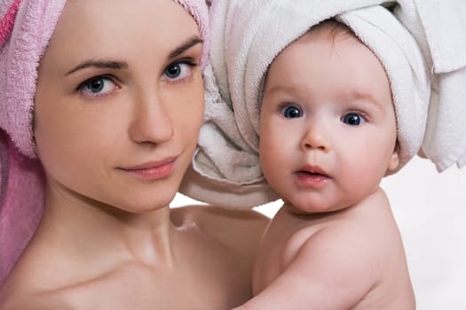 beautiful mother and daughter with a towel