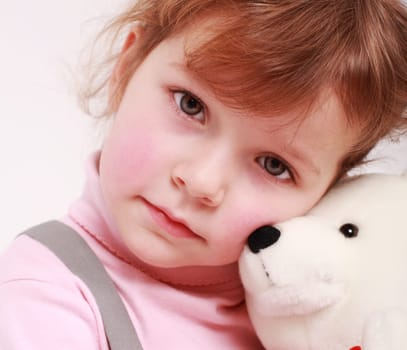 Portrait of sad little girl with teddy