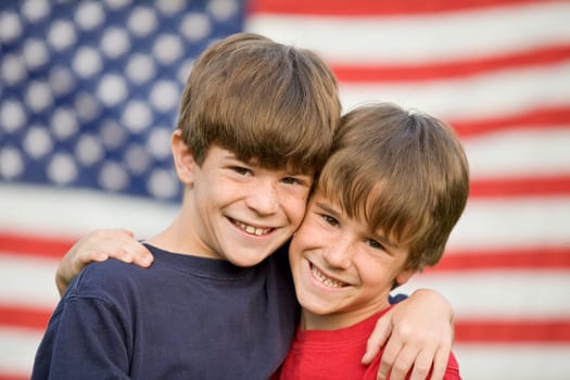 Brothers Hugging in Front of American Flag