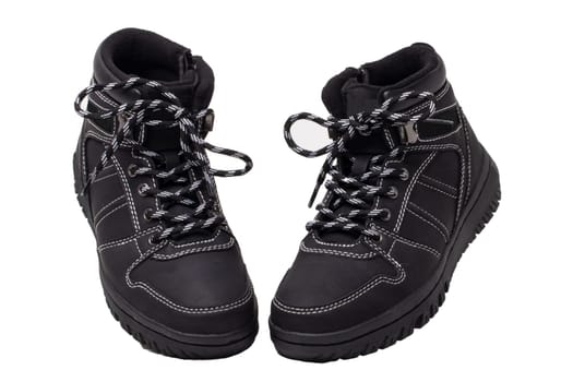 Winter boots. Close-up of a pair elegant black leather winter boots with laces and rivets isolated on white. Macro. Autumn shoe fashion for child boy.