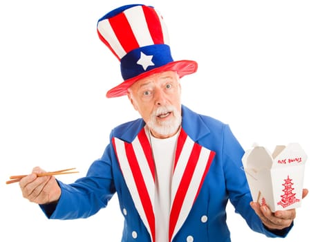 American icon Uncle Sam tries to figure out how to eat Chinese food with chopsticks.  Isoalted on white.