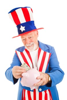 Realistic Uncle Sam saving money in his piggy bank.  Metaphor for American economy.  Isolated
