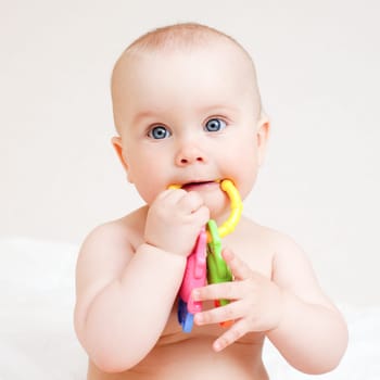 Little baby girl with teething toy