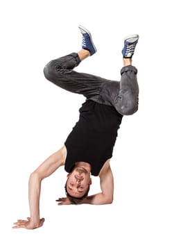 Break dancer doing an one handed handstand against a white background
