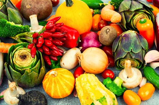 Colorful mix of vegetables. Pumpkin Pepper Cucumber Tomato Artichoke Potato Broccoli Beet. Food background