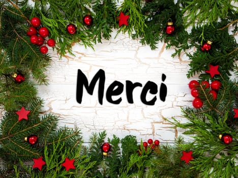 Christmas Card With Fir Branches And French Text Merci Means Thank You. White Wooden Background With Vintage Design And Christmas Decoration Like Red Ornament Balls.