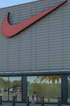 mallorca, balearic islands spain-november 05 2022: woman shopping in Mallorca Fashion Outlet, shopping center sports store nike