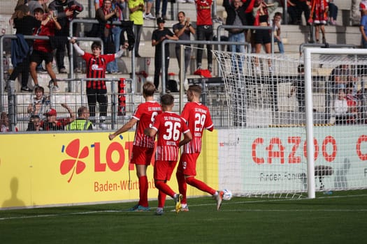 Goal scorer,goal scorer Vincent Vermeij (SC Freiburg II - U23) is celebrated by the fans after his penalty goal,colleagues Julian Guttau (SC Freiburg II - U23) and Maximilian Breunig (SC Freiburg II - U23) come to congratulate him on the game of the 3rd FBL: 22-23: 14th Sptg. SC Freiburg II vs VfB Oldenburg.. DFL REGULATIONS PROHIBIT ANY USE OF PHOTOGRAPHS AS IMAGE SEQUENCES AND/OR QUASI-VIDEONann.. Photo: Joachim Hahne/johapress