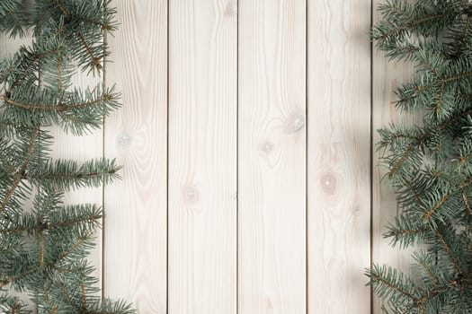 Christmas greeting wallpaper banner with evergreen tree branches decoration and wooden space in center. Frame, border for holiday and creative presents. Xmas background, mockup, top view, copy space