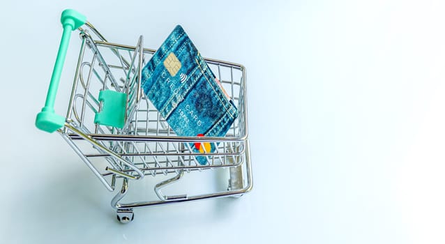 Shopping trolley with credit card on white background. On line shopping concept.