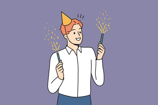Smiling young man in birthday hat holding sparklers celebrating. Happy businessman have fun enjoy fireworks at party. Vector illustration.