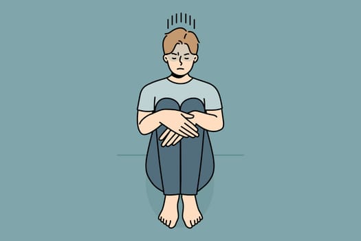 Unhappy young man sitting on floor suffer from loneliness or depression. Upset sad guy struggle from solitude or bad mood. Vector illustration.