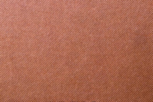 Brown fabric texture. Close-up of a brown seamless pattern for textile, bags or other garments. Macro.