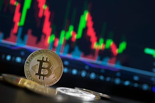Bitcoin and cryptocurrency investing concept. Bitcoin cryptocurrency coins. Trading on the cryptocurrency exchange. Trends in bitcoin exchange rates. Rise and fall charts of bitcoin.