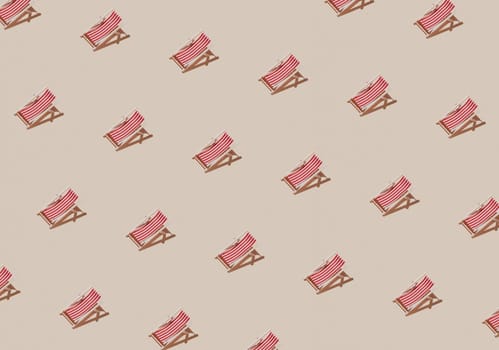 Vacation, beach, travel or relaxation concept. Beige background flat lay as symbol of sand with mini sun lounger for beach chair. Minimalism with copy space area for text, wooden red-white lounge