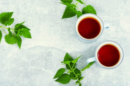Teacup with herbal tea, healing tea with fresh nettle. Homeopathy, herbal medicine.