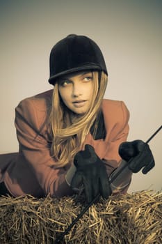 girl jockey / on a background of blue sky and hay / split vintage toned