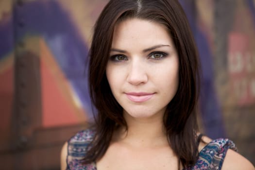 Beautiful Brunette with an edge and darker eye makeup looking at camera