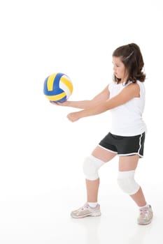 Cute Caucasian girl serving the ball in volleyball