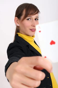 happy woman showing a playing card at the camera