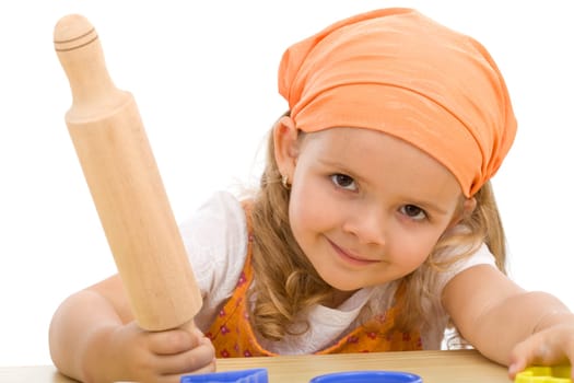 Girl with rolling-pin preparing to make some cookies - isolated