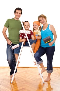 Happy family with painting utensils ready to repaint their home - isolated