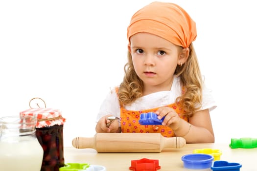 Little girl with utensils and ingredients to make cookies - isolated
