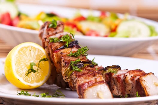 Grilled chicken kebab served with a fresh salad