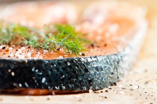 Raw salmon fillet on an old wooden kitchen board