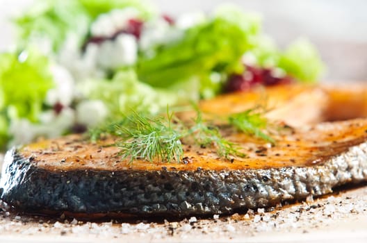 grilled salmon on old wood board garnished with dill