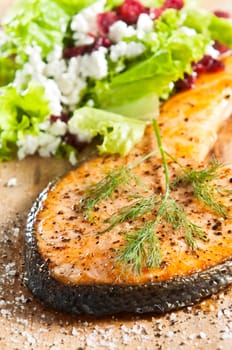 grilled salmon on old wood board garnished with dill