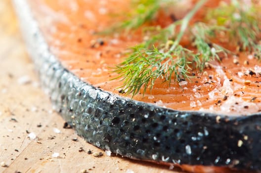 Raw salmon fillet on an old wooden kitchen board