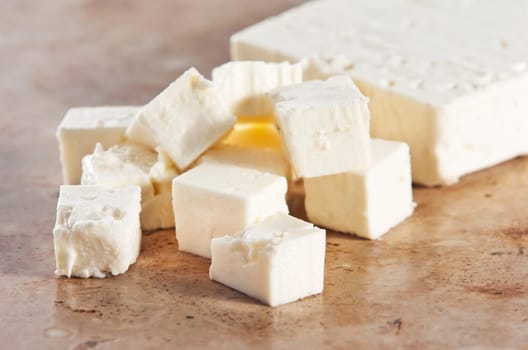 Cubed feta cheese on a kitchen counter