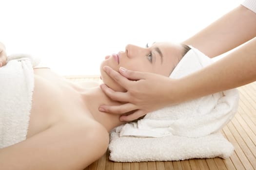 Beautiful woman face massage with towel around her head