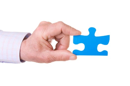 Hand holding a blue puzzle isolated on white