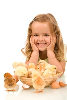 Happy little girl with a basket full of baby chickens - isolated