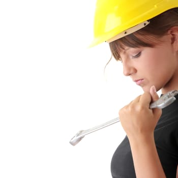 Young woman builder at work with big french key, isolated on white