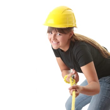 Young woman builder holding yellow rope